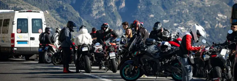 A group of riders on a scenic mountain road