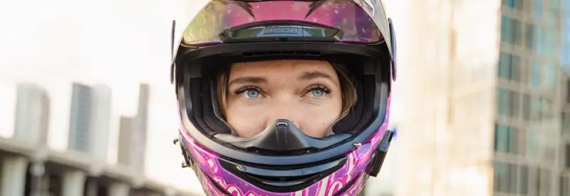 A portrait of a woman in her riding helmet