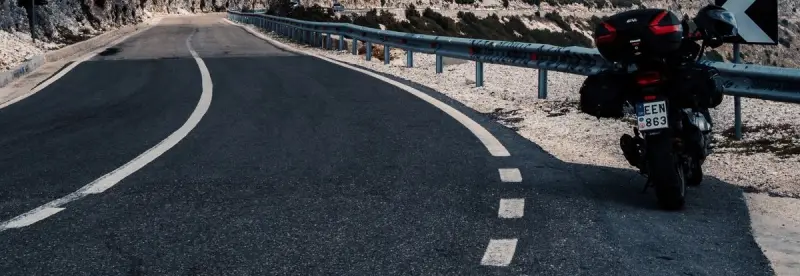 A black motorcycle parked by a mountain road