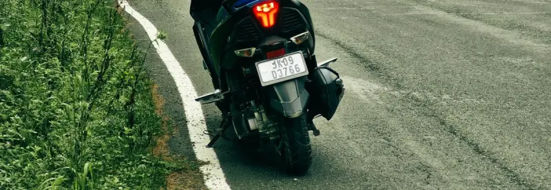 A parked motorbike on a scenic mountain road