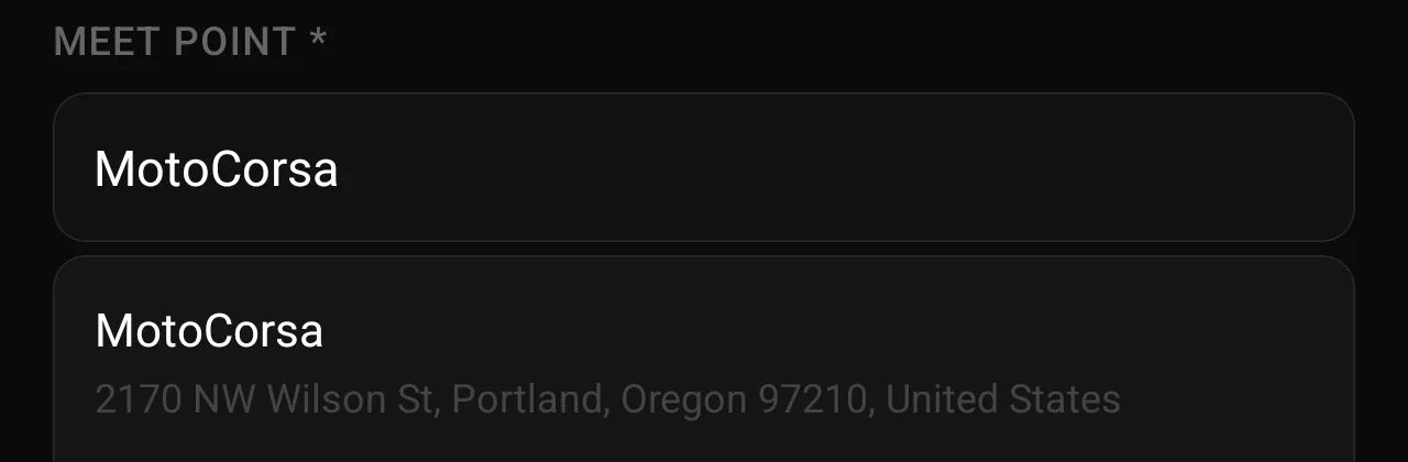 The meet point field when scheduling a ride, with a dealership name typed in and the matching business suggested with its address